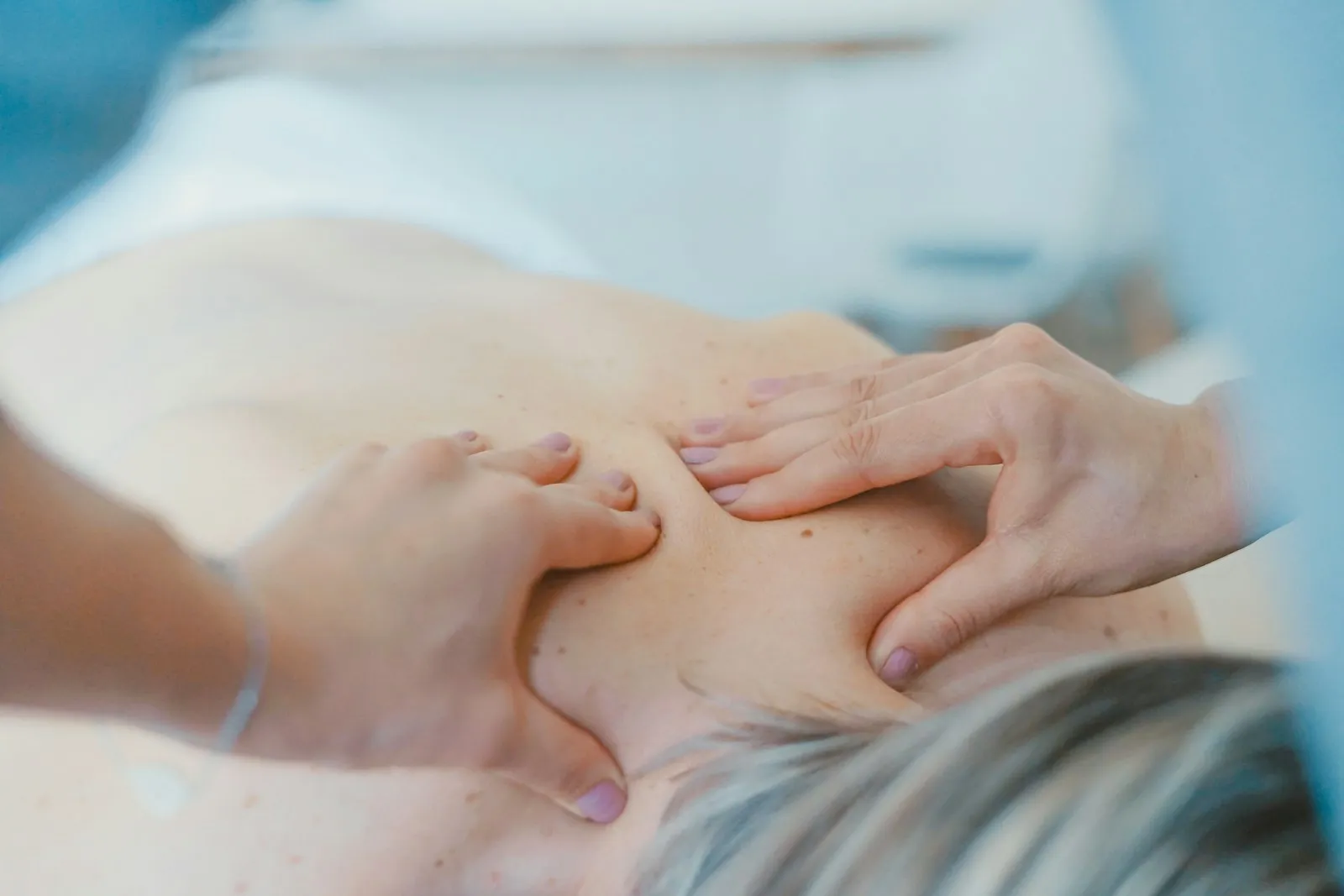 A woman unwinding during a calming home massage session in Delhi